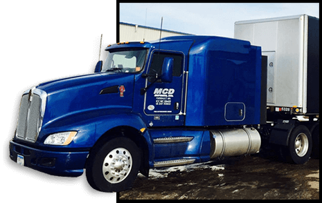 Royal blue MCD Express semi tractor driving out of a photo frame